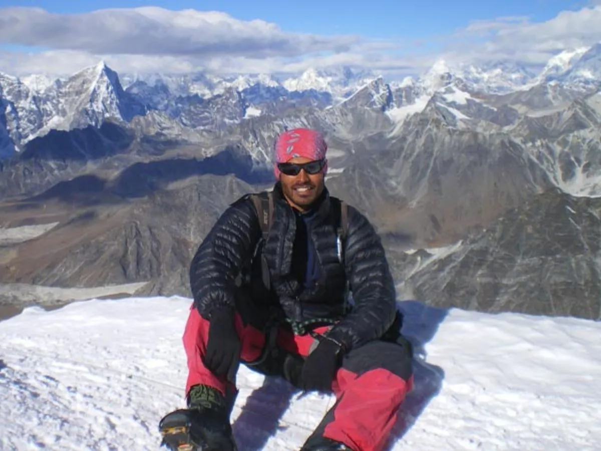 Kyajo ri climber taking picture and mountain view at the background